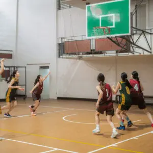 Indoor women's basketball game in action.