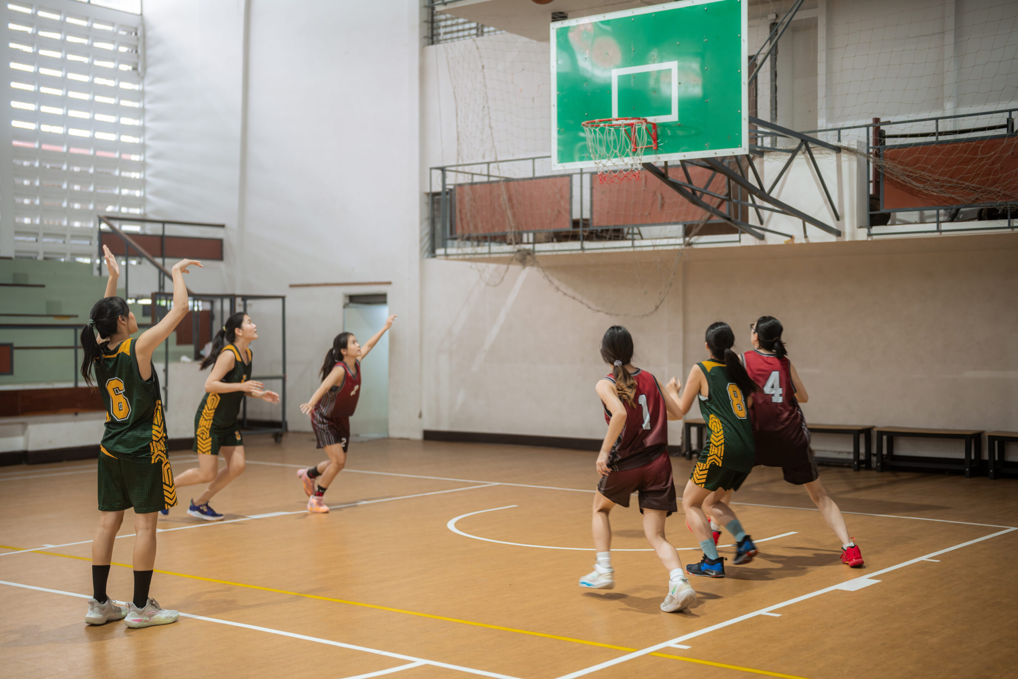 Women's basketball game in action indoors.